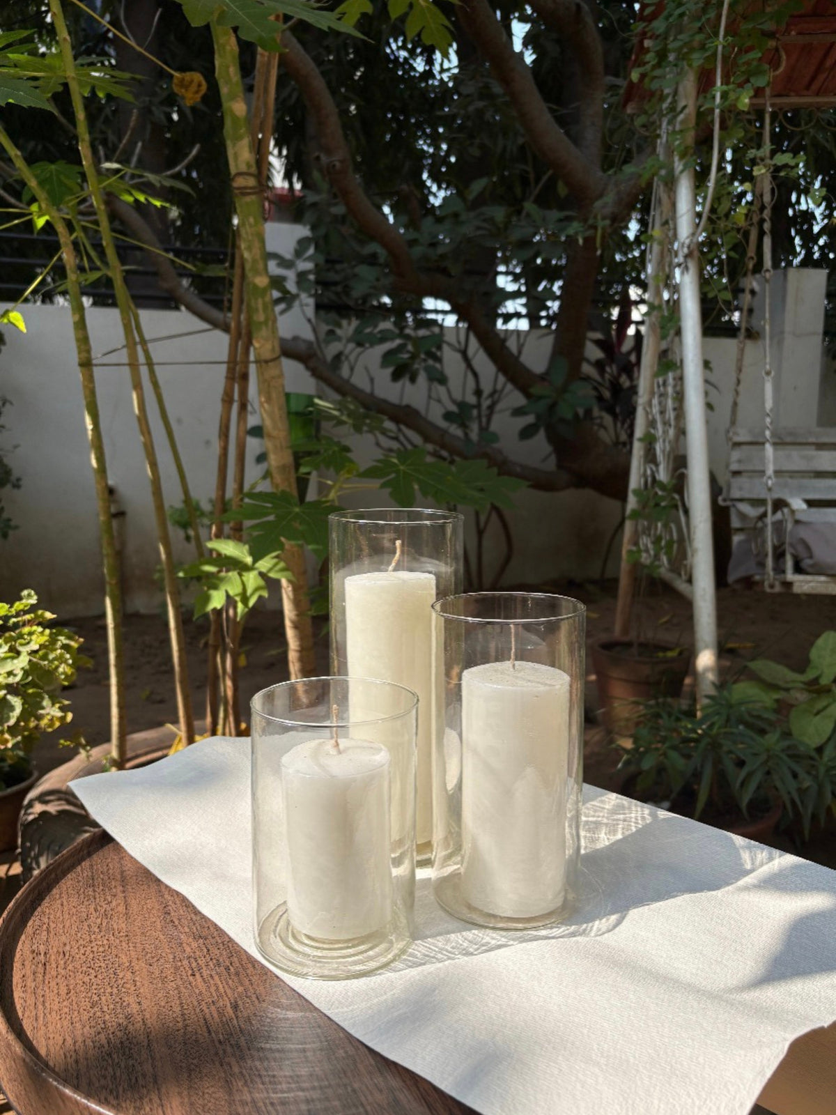 Pillar candle with glass column, a perfect pairing for home decor or outdoor settings.