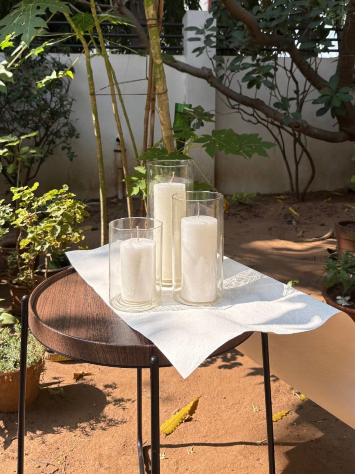 Indiglow pillar candle displayed with a glass column holder.